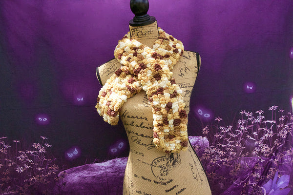 Beige crochet pompom scarf. This is a fluffy, adult scarf measuring 40 inches in length.